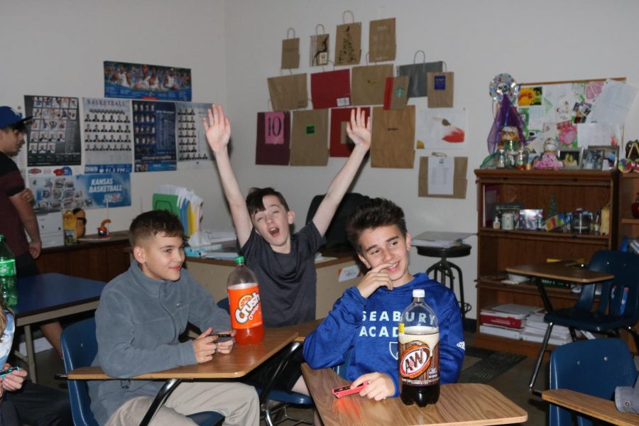 Seventh graders Sebastian Borjas, Sean Ruddy and Raphael Queiroz watch Super Smash Bros. during the Halloween carnival. Ruddy said his favorite thing about the carnival was the free candy and the snow