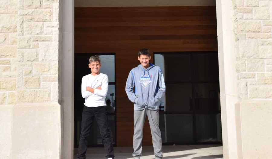 Sixth grader Mateo Sherwood and his eighth grade brother, Lucas Sherwood, pose in front of Seabury. They both return to Seabury fluent in Spanish.