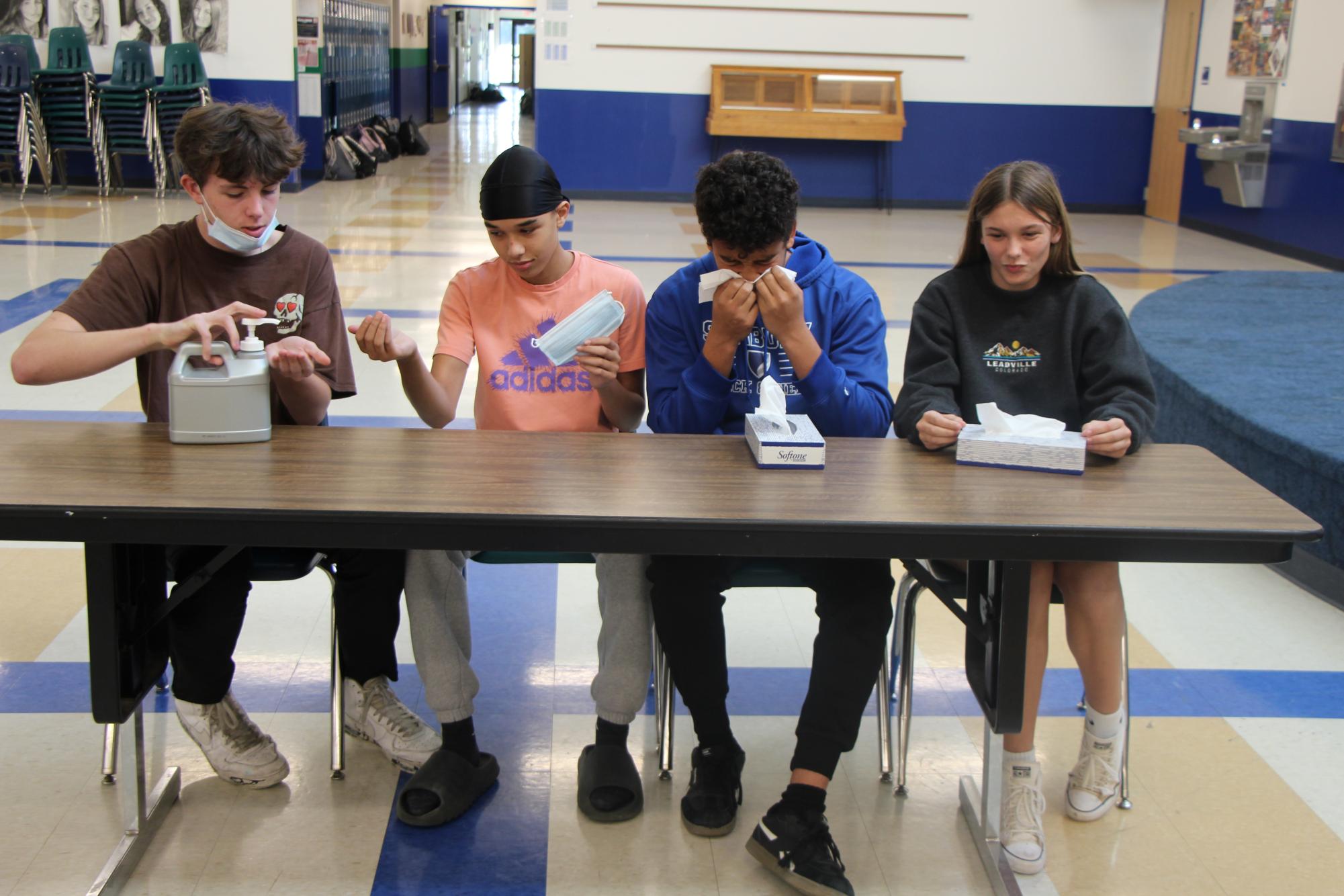 Junior Liam Smith, freshman Eliot Ardery, junior Roman Ardery and eighth grader Eva Etzel all exhibit cleanliness practices at school. Pneumonia spread through the school faster than a virus spreads through the immune system. 