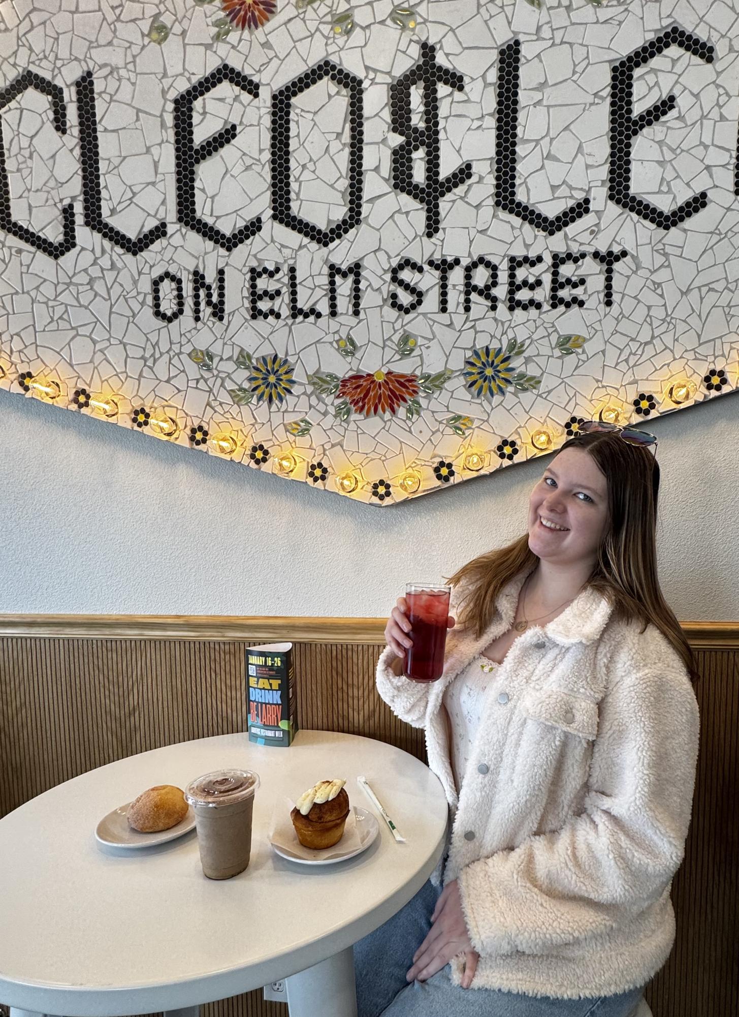 Senior Margaret Mulhern holds up a hibiscus berry iced tea from Cleo and Leo, a new restaurant in town. Mulhern raved about the impeccable treats and atmosphere. 