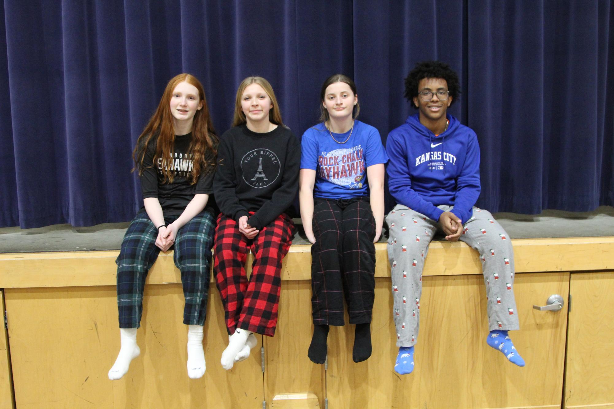 Seventh grader Lucy Kneidel, eighth grader Zoe Huebner, seventh grader Isa Heidewald and eighth grader Addis Newell enjoy their break during P.E. in their pajama bottoms. More and more kids everyday are rocking this new style. 