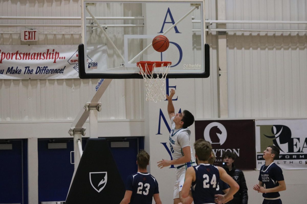 Senior Chase Honarvar puts away the winning basket against Cair Paravel Latin School. Dillon Gymnasium brings the Seahawks good luck, for they have yet to lose a game on their home turf. 