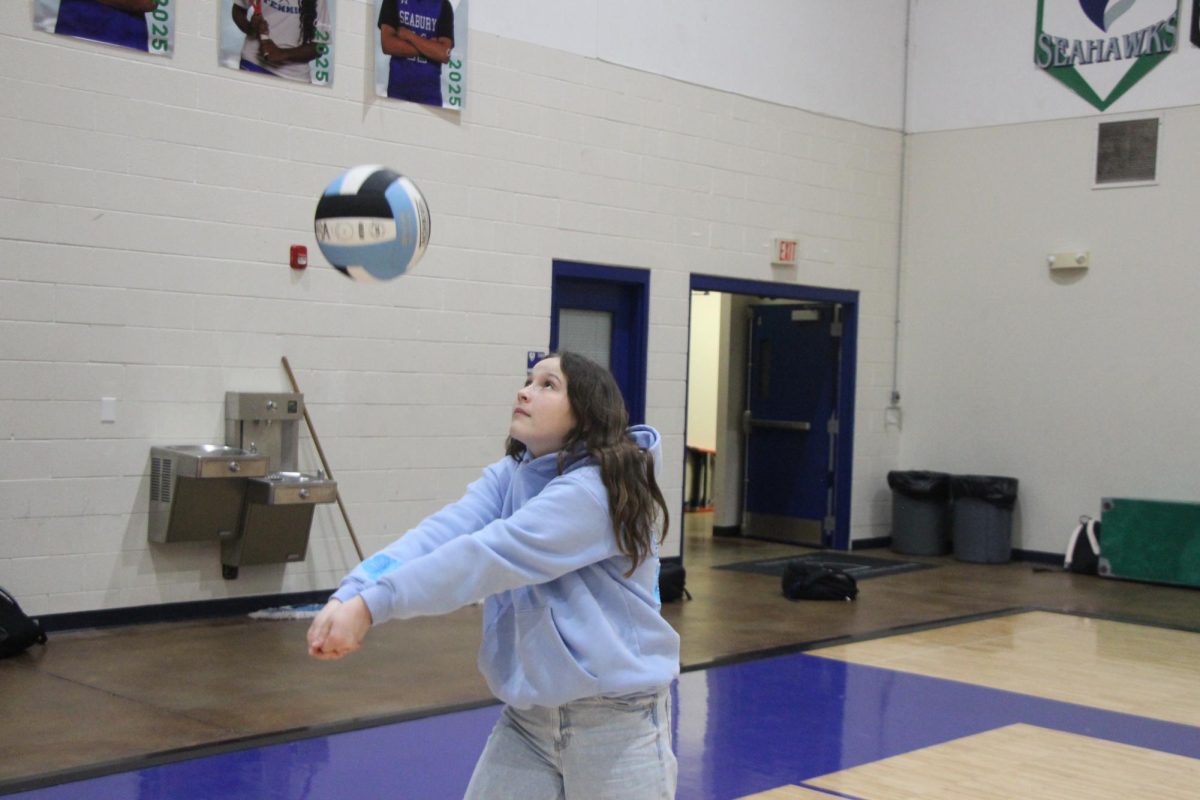 Seventh grader Savannah Mizer bumps a volleyball in the Bishop Seabury Gymnasium. Mizer plays volleyball for both Bishop Seabury and the Lawrence Landsharks.