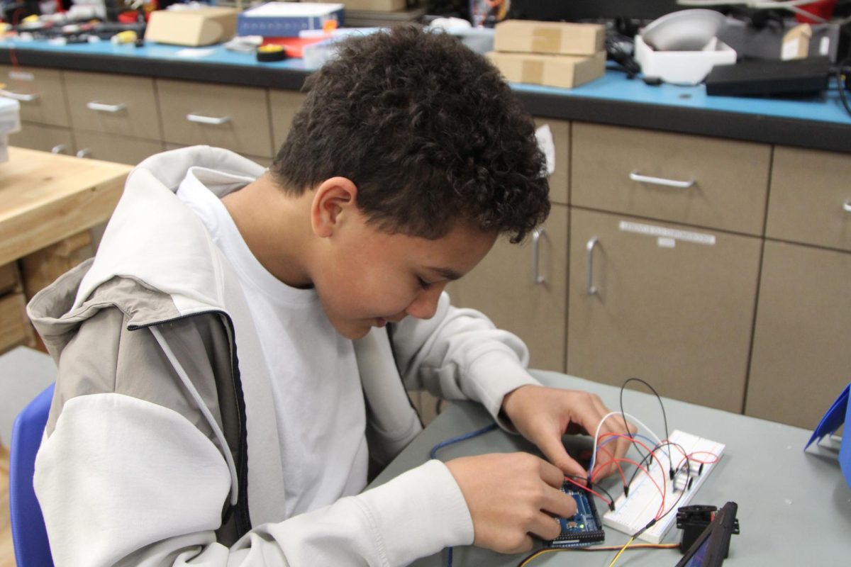 Freshman Henry Kimuri concentrates while working on a project for robotics class. This is one of two of Kimuri's elective classes, including Instrumental Music.