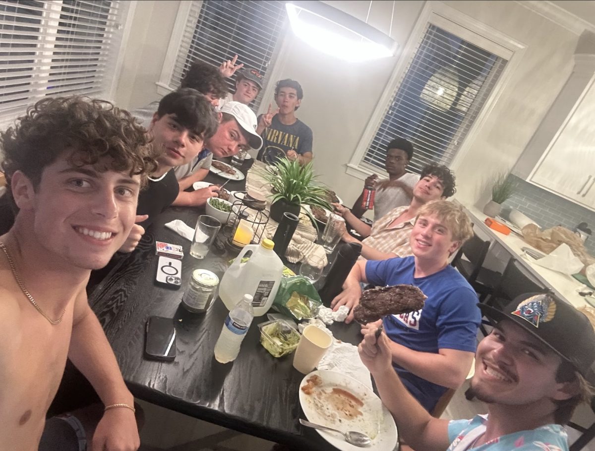 A group of seniors smile as they enjoy a delicious dinner on Anna Maria Island in Florida. Senior Aiden Najafizadeh notably brandishes senior Gabe Rinnerts' home-cooked steak due to its incredible quality.