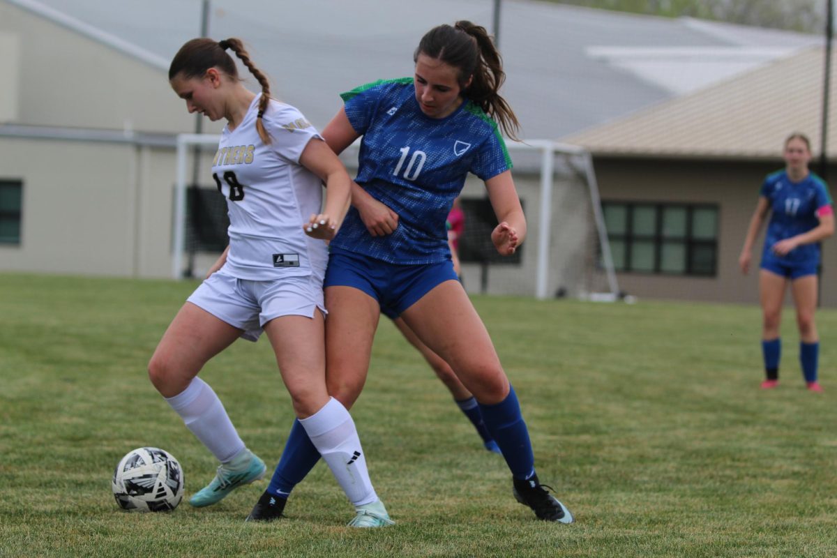 Sophmore Chelsea Walden attempts to steal the soccer ball from the opposing team. The high school girls' soccer team has exhibited an impressive season so far, mercy-ruling many of their opponents.